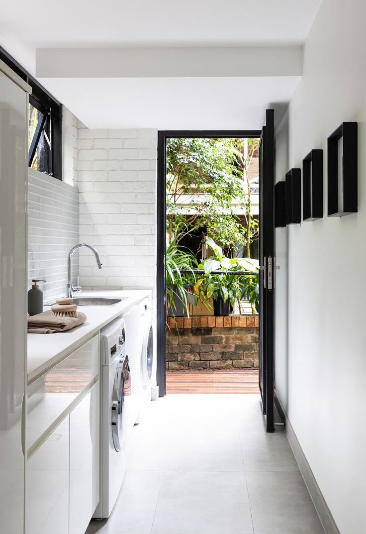 Laundry renovation with storage and tiled splashback